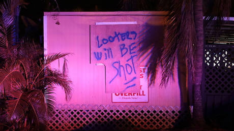 FILE PHOTO: A sign in front of residents' homes warn away looters four days after Hurricane Irma September 14, 2017 on Stock Island, Florida