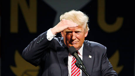 FILE PHOTO: Donald Trump shields his eyes to look out at the audience during a campaign rally in Greensboro, North Carolina June 14, 2016