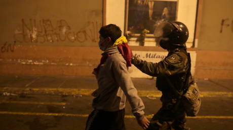 A police officer detains a man during protests in Lima, Peru on November 12, 2020. © REUTERS/Sebastian Castaneda