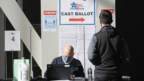 A poll worker checks the registration of a voter in Chicago, Illinois.