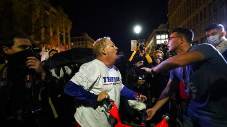 A supporter of US President Donald Trump surrounded and harassed by counter-protesters in Washington, US, November 14, 2020