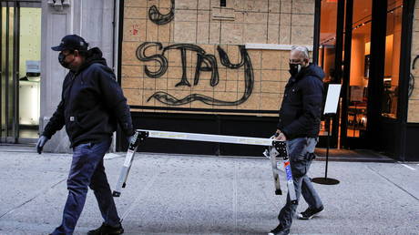 Workers board up a store in the Manhattan borough of New York, US, November 2, 2020