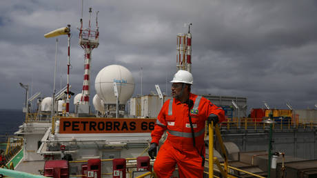 A worker walks on the heliport at the Brazil's Petrobras P-66 oil rig in the offshore Santos basin in Rio de Janeiro, Brazil