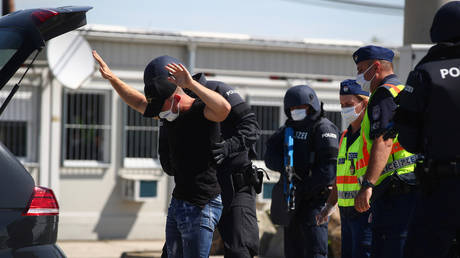 FILE PHOTO: Austrian and Hungarian police officers attend an exercise to prevent migrants from crossing the Austrian border from Hungary in Nickelsdorf, Austria, July 2, 2020.