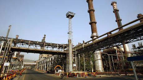 A worker rides a bicycle at Bharat Petroleum Corporation Ltd. refinery in Mumbai, India