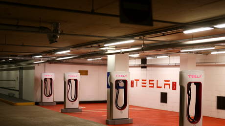 A Tesla electric charging point stands unused in a car park in UK
