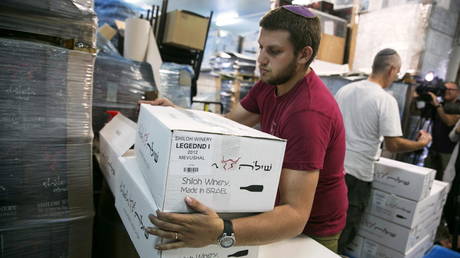 A worker carries boxes containing wine bottles for export at Shiloh Wineries, north of the Israeli-occupied West Bank city of Ramallah, November 8, 2015. © Reuters / Baz Ratner / File Photo