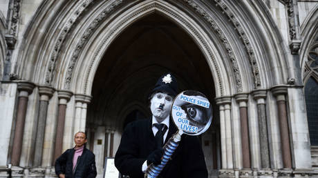FILE PHOTO: A demonstrator outside the Royal Courts of Justice, London, where an Investigatory Powers Tribunal is hearing the case of Kate Wilson who was deceived into a relationship by undercover police officer Mark Kennedy