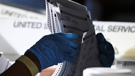 An employee of the Fulton County Board of Registration and Elections processes ballots in Atlanta, Georgia US., November 4, 2020.