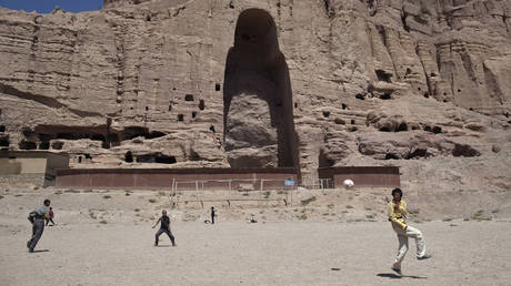 Afghan boys play soccer in front of the remains of a 1,500-year-old Buddha statue which was destroyed by the Taliban in March 2001, in the central province of Bamiyan, August 22, 2011. © Reuters / Ahmad Masood