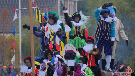 FILE PHOTO: People dressed as traditional character known as Zwarte Piet or Black Pete arrive on a boat with Sinterklaas (St. Nicholas) November 24, 2018, in Katwijk, Netherlands