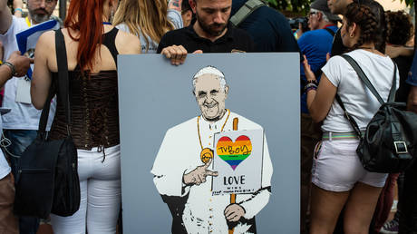 An LGBT activist with a poster on which Pope Francis is drawn with a heart in the colors of the rainbow, during the Avellino Pride 2019 on June 15, 2019 in Atripalda, Italy.