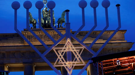 A giant menorah before its illumination during the Jewish holiday of Hanukkah in Berlin. December 2019. © Reuters / Michele Tantussi