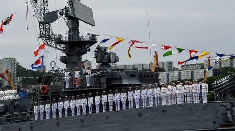 Crew on the deck of one of the ships of the Pacific fleet at the parade in honor of the Navy Day in the Golden horn Bay in Vladivostok.