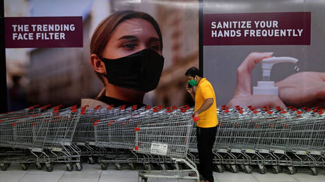 A man wearing a protective mask inside a mall after it reopened following the coronavirus disease outbreak, in Mumbai, India