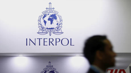 A man passes Interpol signages at Interpol World in Singapore (FILE PHOTO) © REUTERS/Edgar Su