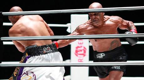 Mike Tyson in action against fellow ring veteran Roy Jones Jr.