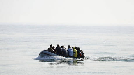A group of people thought to be migrants arrive in an inflatable boat at Kingsdown beach after crossing the English Channel, near Dover, England, Sept. 14, 2020. &copy; AP / Gareth Fuller / PA