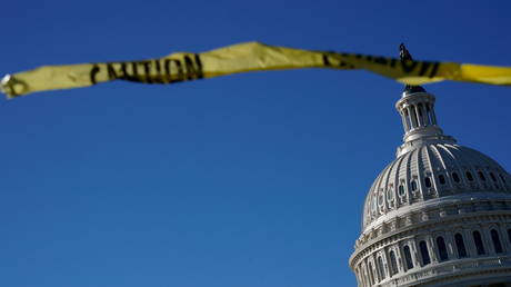 The US Capitol is shown with caution tape in the foreground.