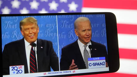 FILE PHOTO: In this photo illustration the US President Donald Trump and Democratic presidential candidate and former US Vice President Joe Biden are seen during the first presidential debate on a YouTube video displayed on a screen of a smartphone