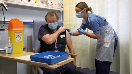 A man receives the Pfizer vaccine in Scotland, December 8, 2020