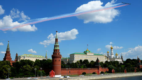 Airplanes paint the sky in the colors of the Russian flag during a Kremlin flyover, June 24, 2020