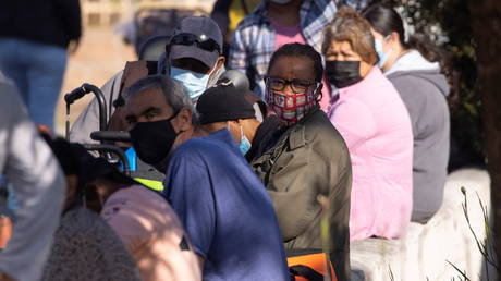 FILE PHOTO: People wait in line as the Los Angeles Regional Food Bank distributes food outside a church during the outbreak of the coronavirus disease (COVID-19) in Los Angeles, California, U.S., November 19, 2020.