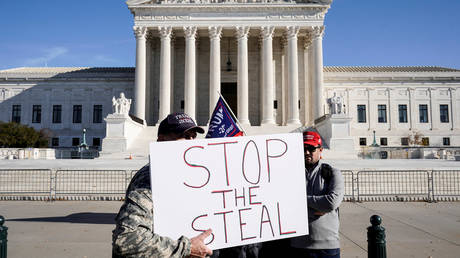 FILE PHOTO: Supporters of U.S. President Donald Trump stand in front of the Supreme Court as the court reviews a lawsuit filed by Texas seeking to undo President-elect Joe Biden's election victory in Washington, U.S., December 11, 2020