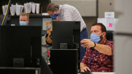 Election workers adjudicate ballots at the Maricopa County Tabulation and Election Center (MCTEC) in Phoenix, Arizona, US, November 9, 2020.