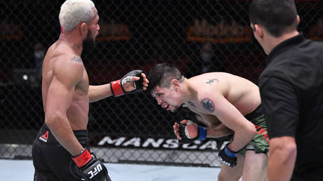 Moreno took a low blow during his title fight with Figueiredo at UFC 256. © Zuffa LLC