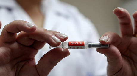 FILE PHOTO: A nurse holds a dose of a potential vaccine against the coronavirus before administering it to a volunteer at the Emilio Ribas Institute in Sao Paulo, Brazil.