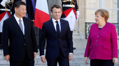 FILE PHOTO: French President Emmanuel Macron, German Chancellor Angela Merkel and Chinese President Xi Jinping leave following a meeting at the Elysee Palace in Paris, France, March 26, 2019