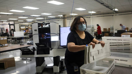 Election workers count ballots at the Maricopa County Tabulation and Election Center (MCTEC), in Phoenix, Arizona, U.S., November 6, 2020.