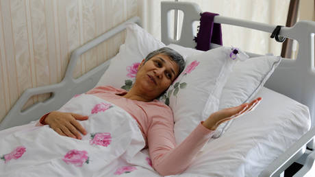 FILE PHOTO: Leyla Guven, pro-Kurdish Peoples' Democratic Party (HDP) lawmaker who has been on a hunger strike for more than four months, gestures as she rests in her bed at her home in Diyarbakir, Turkey, March 20, 2019.