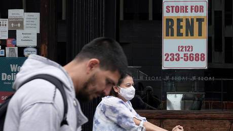 People walk past a shuttered store following the outbreak of coronavirus disease in New York City, October 1, 2020.