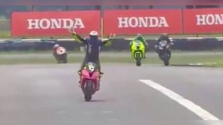 &lsquo;What an idiot!&rsquo; Fans slaughter smug motorcycle racer whose early celebrations cost him victory at finish line