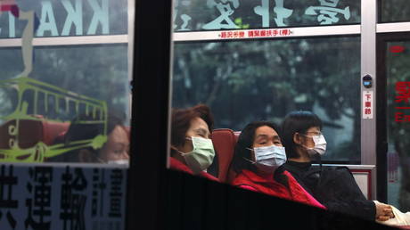 People sit in a bus while wearing protective masks in Taipei, Taiwan, December 22, 2020. © REUTERS/Ann Wang