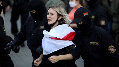 FILE PHOTO: Belarusian law enforcement officers detain a woman during an opposition rally in capital Minsk. © Reuters / BelaPAN
