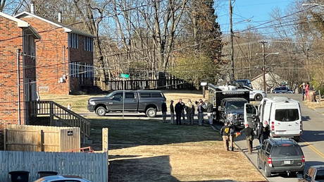 Law enforcement officers gather to investigate information arising the day after a downtown Nashville explosion, outside a duplex house in Antioch, Tennessee, U.S. December 26, 2020