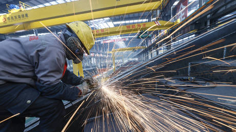 FILE PHOTO:  Employees process steel products at a factory of Huazhao Dongnan (Yuncheng) Green Building Integration Co., Ltd on December 16, 2020 in Yuncheng, Shanxi Province of China.
