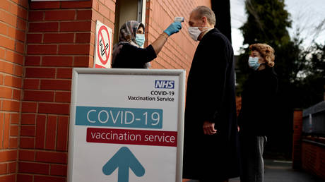 FILE PHOTO: Patients enter a clinic to receive their first of two injections of a coronavirus vaccine jointly developed by Pfizer and BioNTech, in Wolverhampton, Britain.