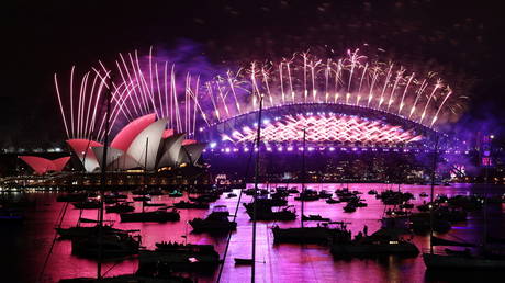 Fireworks explode over the Sydney Opera House and Sydney Harbour Bridge during downsized New Year's Eve.