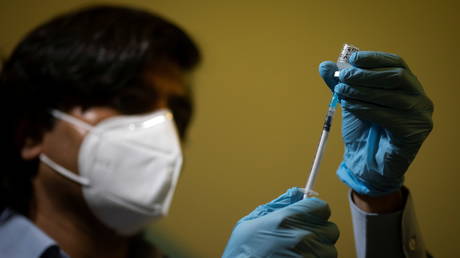 FILE PHOTO: A medical worker draws an injection of the Pfizer-BioNTech coronavirus vaccine into a syringe at the Hurley Clinic in London, Britain.