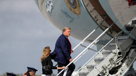 FILE PHOTO: U.S. President Donald Trump boards Air Force One with first lady Melania Trump at Palm Beach International Airport in Florida, US, December 31, 2020