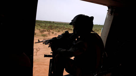 FILE PHOTO. A French soldier mans a machine gun in the door of a NH 90 Caiman military during Operation Barkhane in Mali.