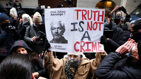 People celebrate after a judge ruled that WikiLeaks founder Julian Assange should not be extradited to the United States, outside the Old Bailey, the Central Criminal Court, in London, Britain, January 4, 2021.