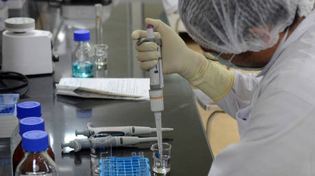 FILE PHOTO: A research scientist works in a laboratory of India's Serum Institute as it develops vaccines against the coronavirus, in Pune, India.