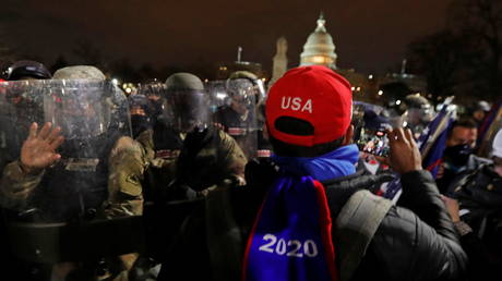 Police pushes supporters of US President Donald Trump away from the US Capitol, January 6, 2021.