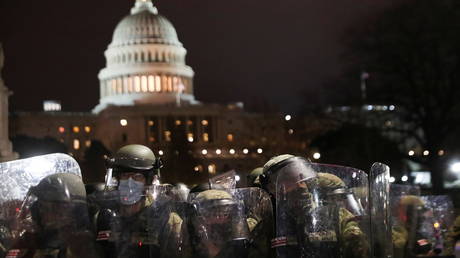 National Guard troops stand guard as supporters of President Donald Trump gather outside the US Capitol building during a protest against the certification of the 2020 election results, in Washington, DC, January 6, 2021.