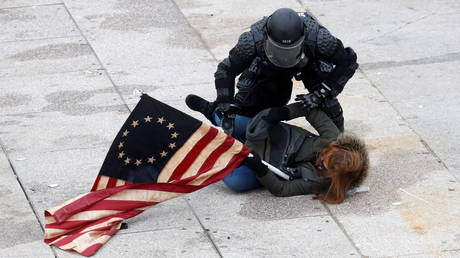 A Trump supporter is detained at the US Capitol building, January 6, 2021.